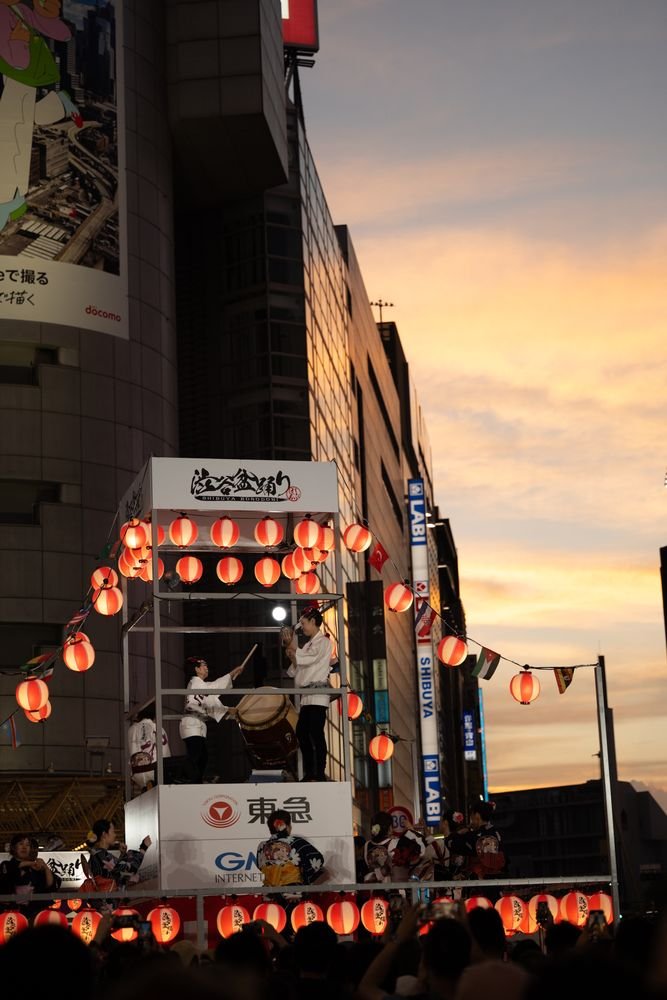 Dancers and lantern-lit crowd at a traditional Japanese bon dance festival