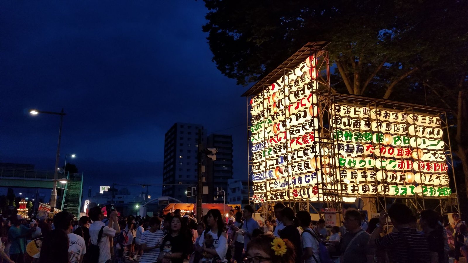 Crowd gathered near a lantern display at a Japanese summer festival
