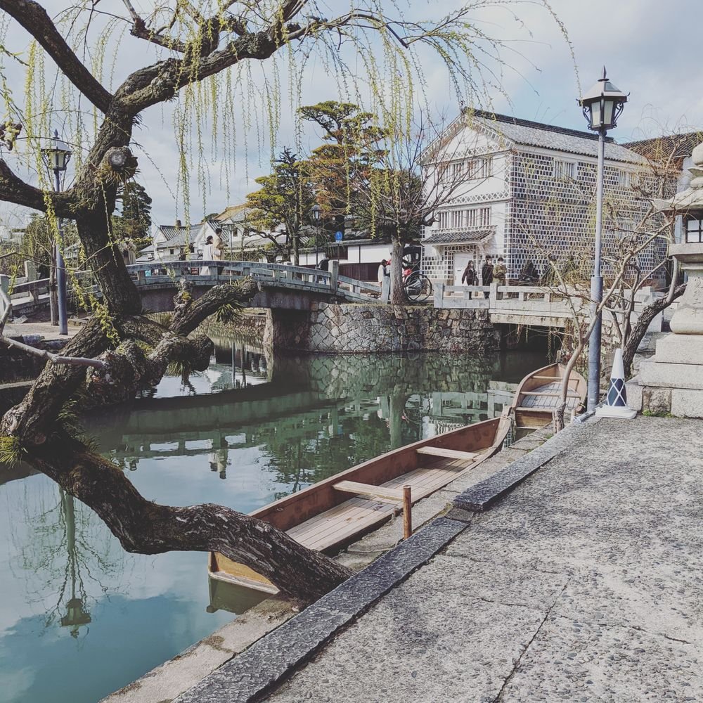 Historic canal running through Kurashiki's Bikan district lined with traditional buildings
