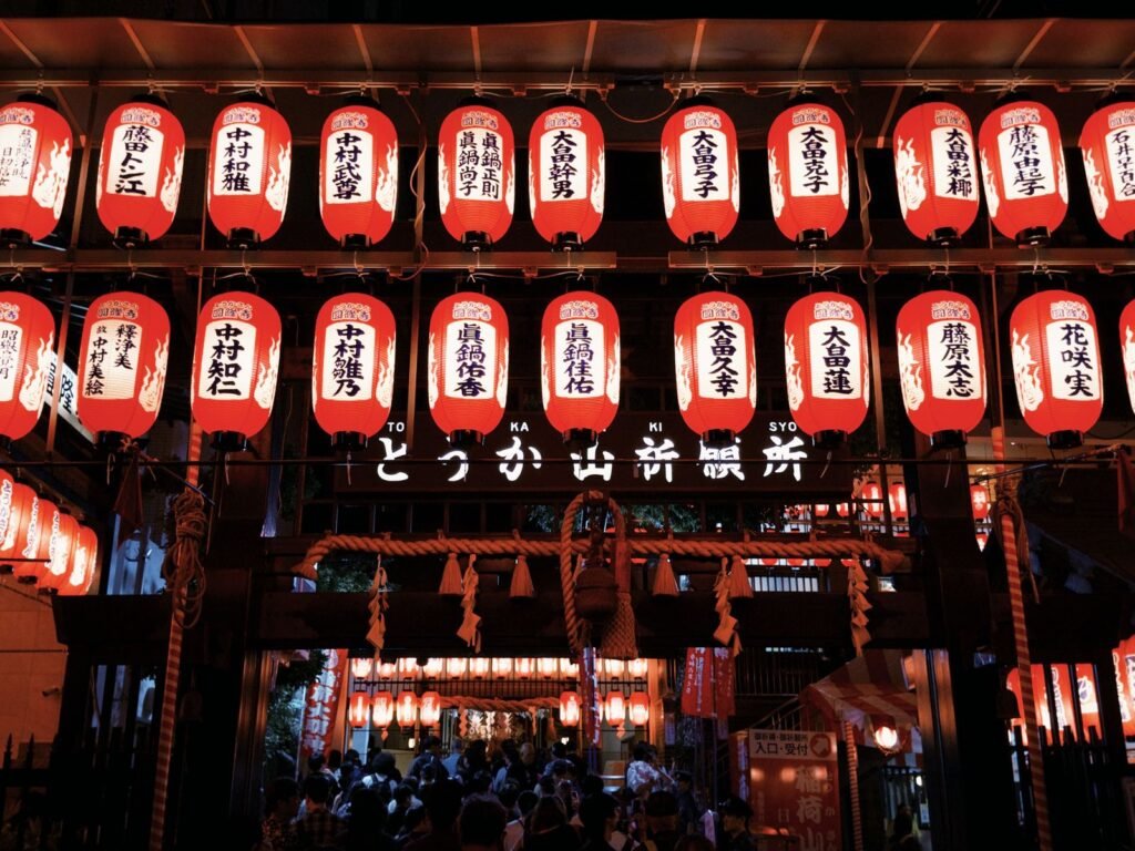 Paper lanterns lit up at night during a Japanese autumn festival