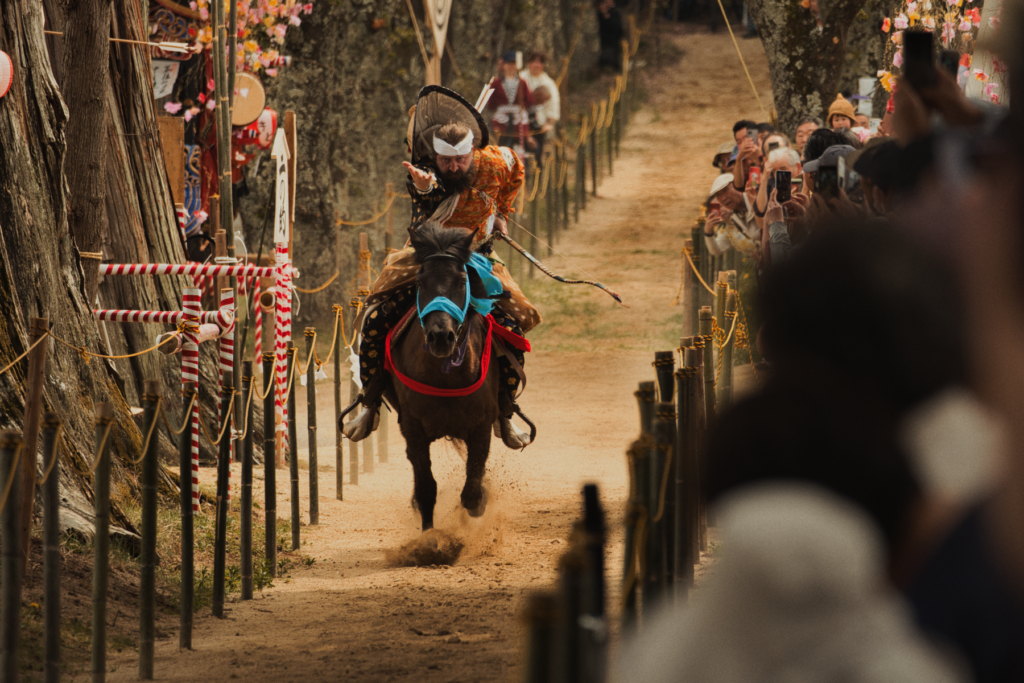 Samurai in traditional armor on horseback during a Japanese festival procession