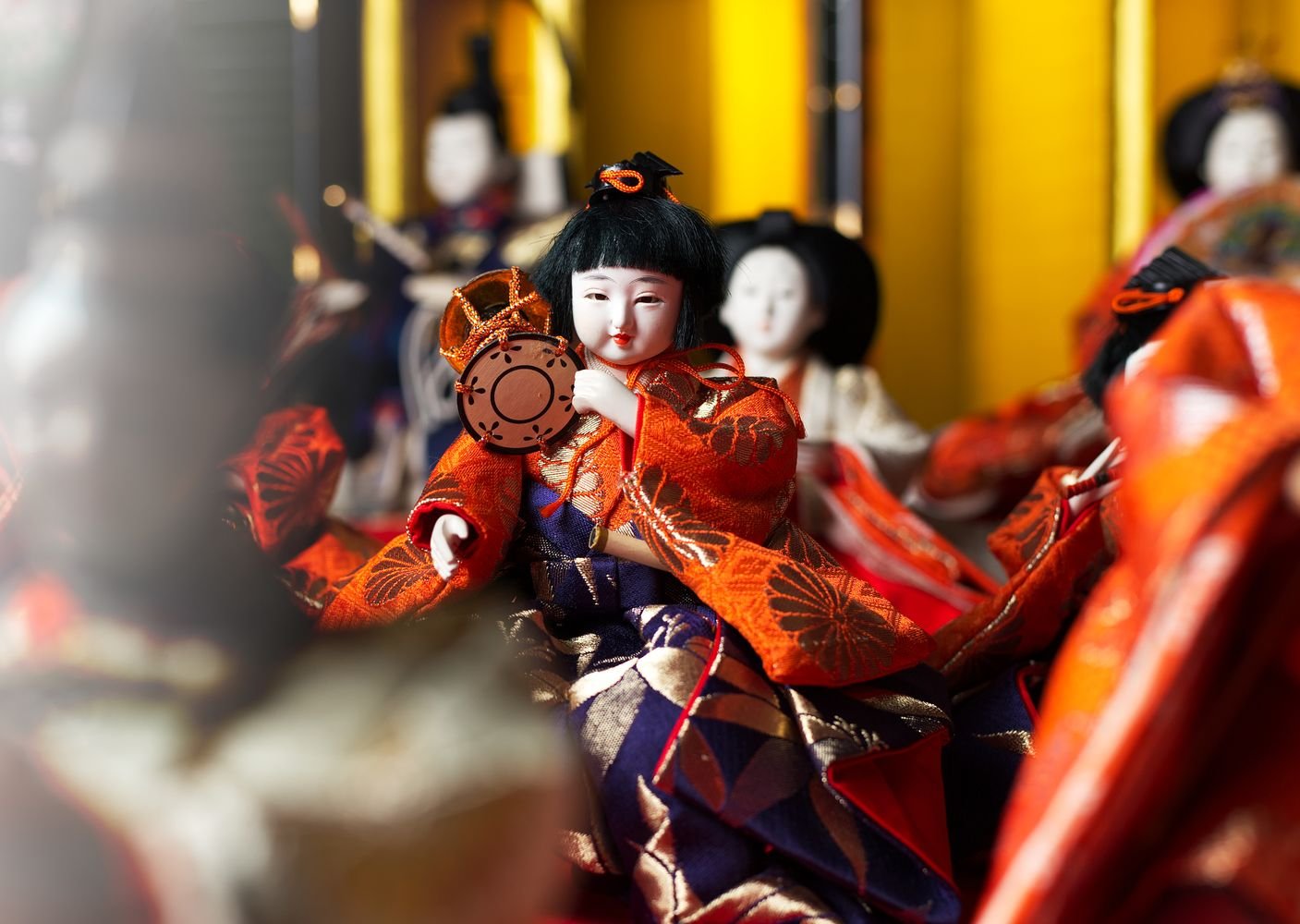Close-up of traditional Japanese dolls in kimono displayed together