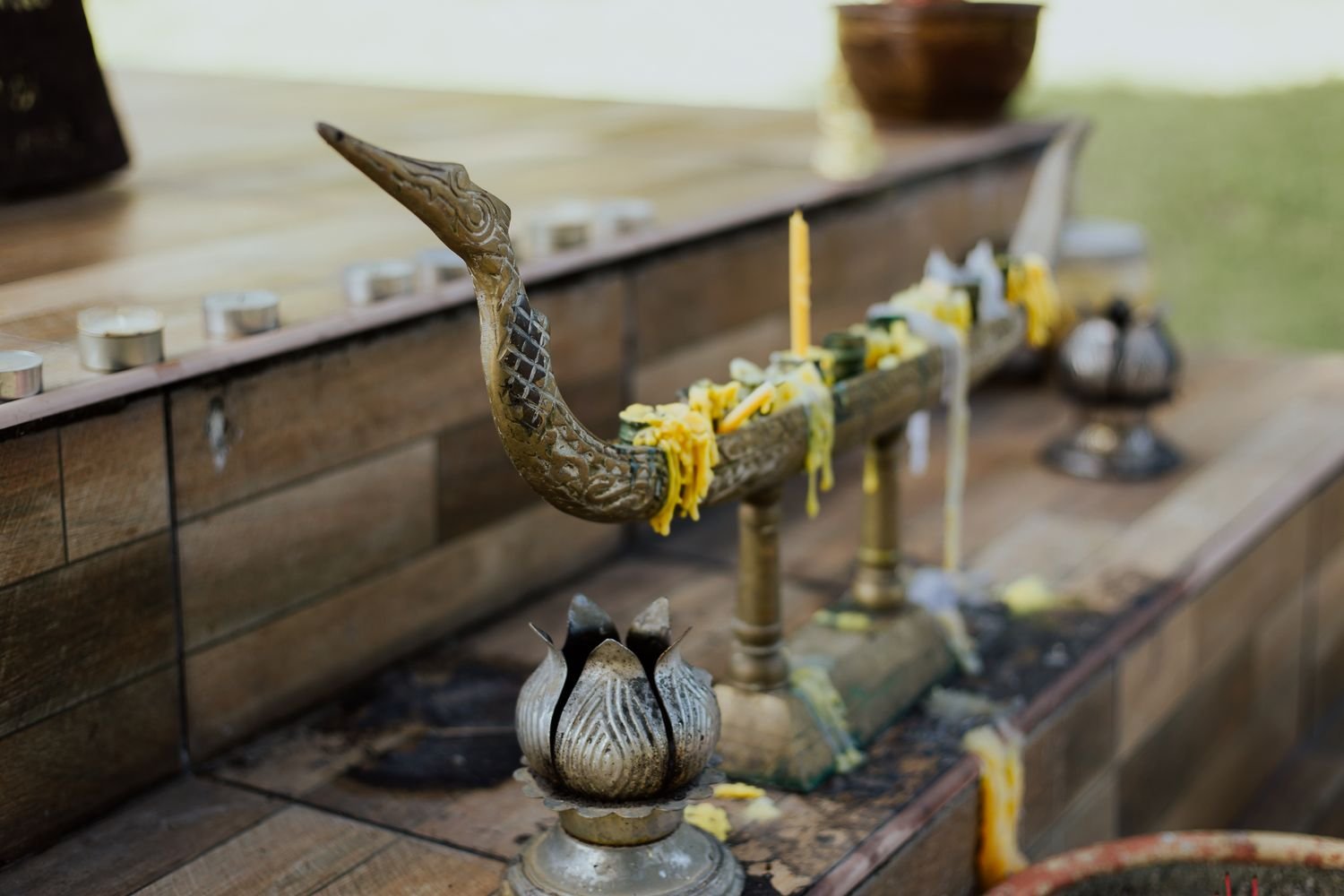 A Buddhist altar with lit candles and religious items, similar to the kind kept in a Japanese household