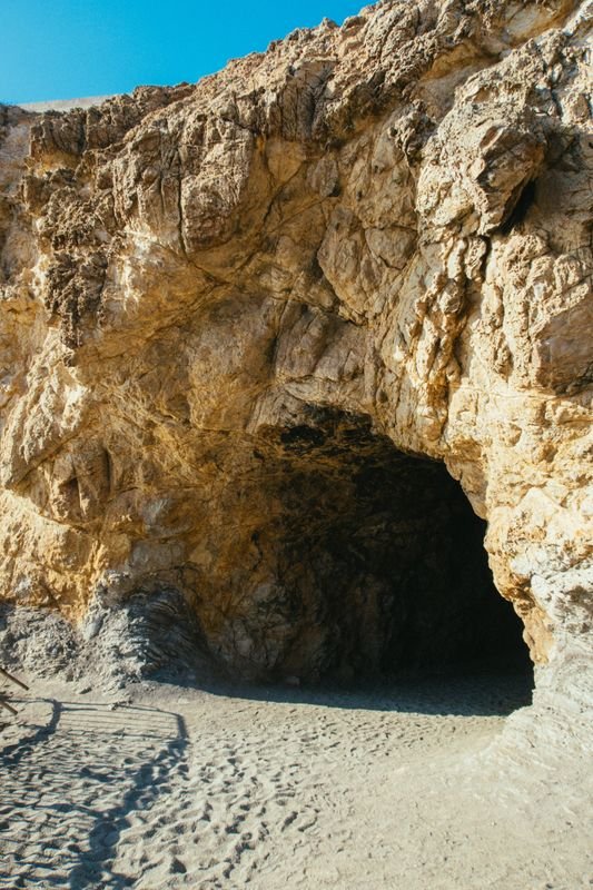 A dim, narrow cave opening in rock
