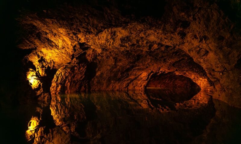 Mysterious underground cave with reflections, illustrative of Japan's underground stone quarries