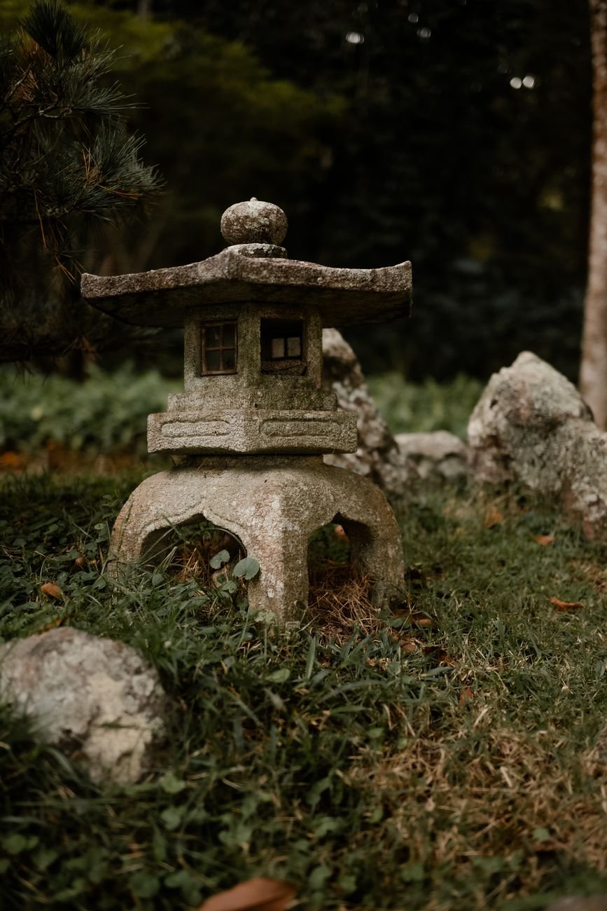 A quiet stone monument in a tranquil Japanese park setting