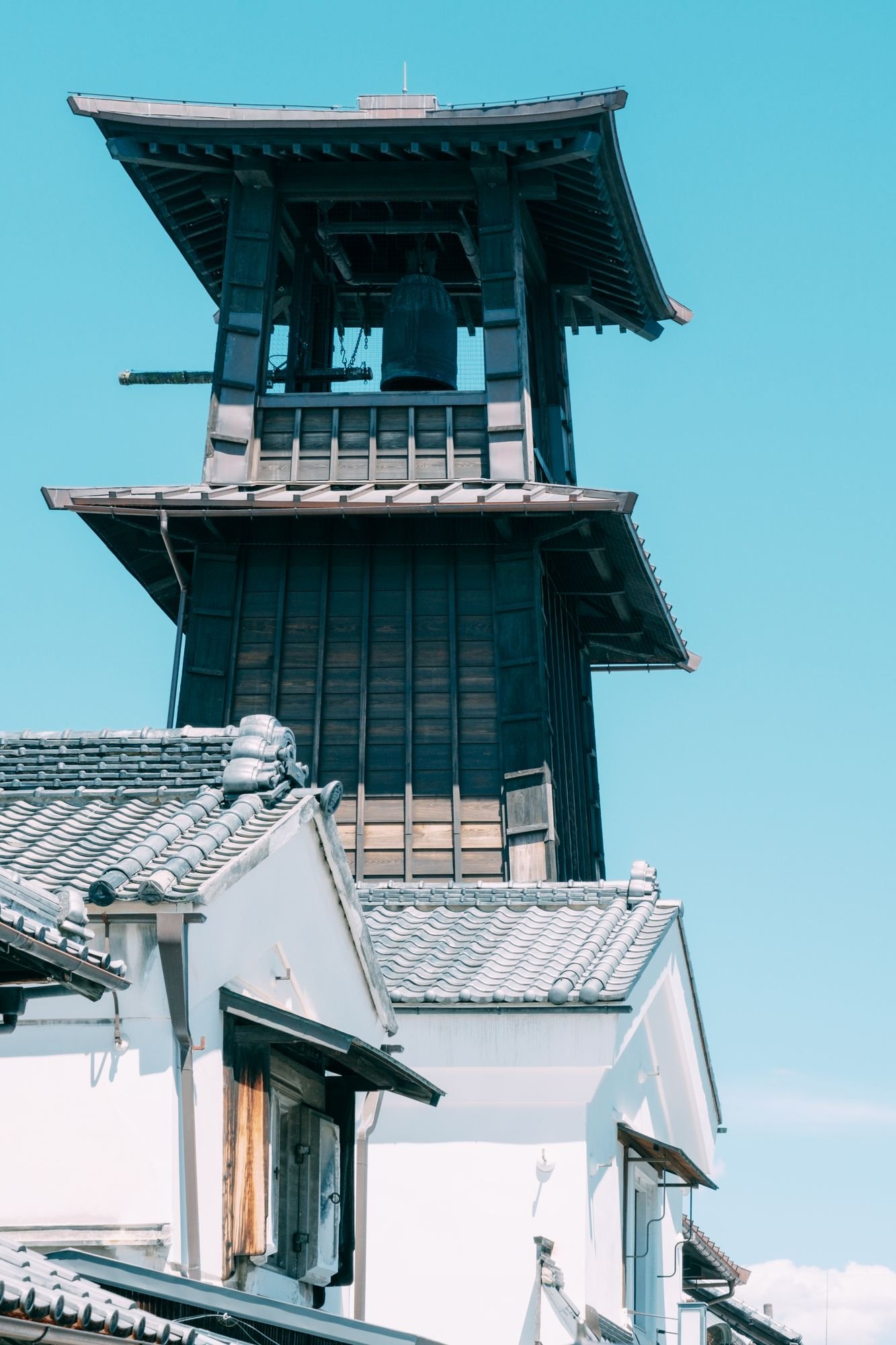 Low angle shot of historic Time Bell Tower in Kawagoe, Japan against a clear blue sky