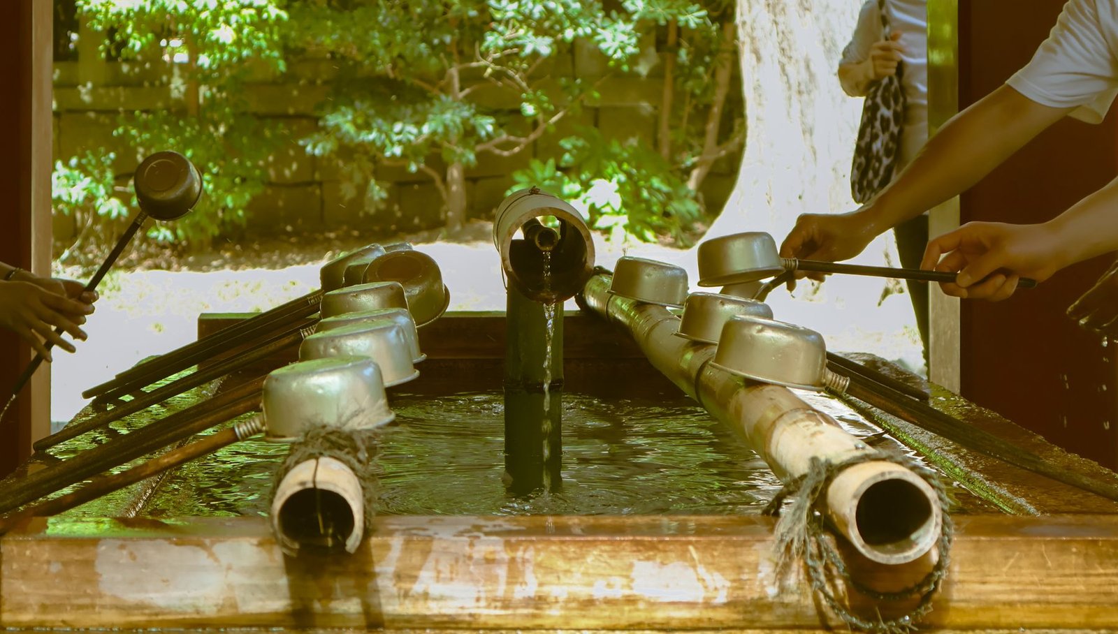 Traditional water purification ritual with ladles at a Japanese Shinto shrine