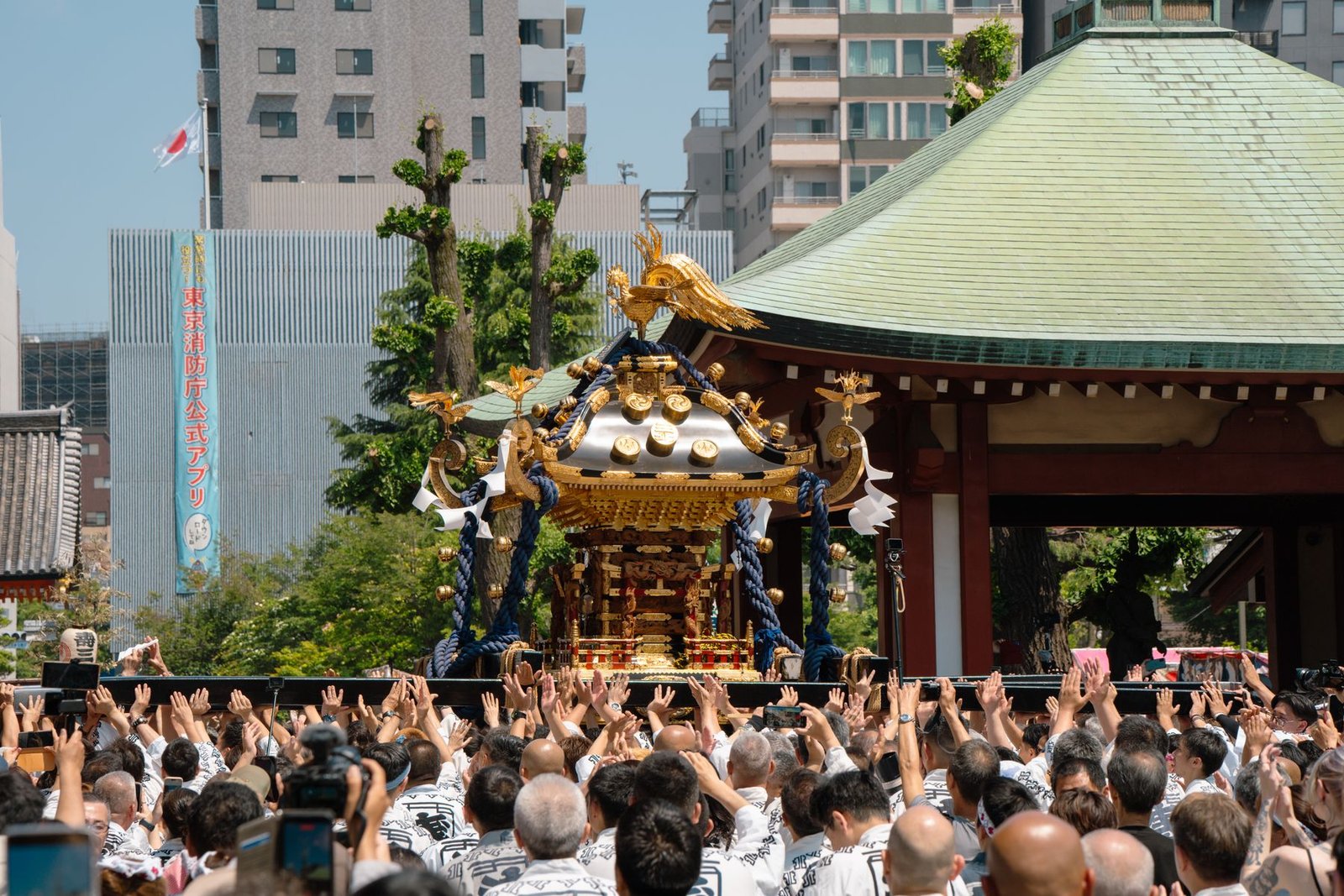 Crowds cheer a mikoshi during a vibrant Japanese festival