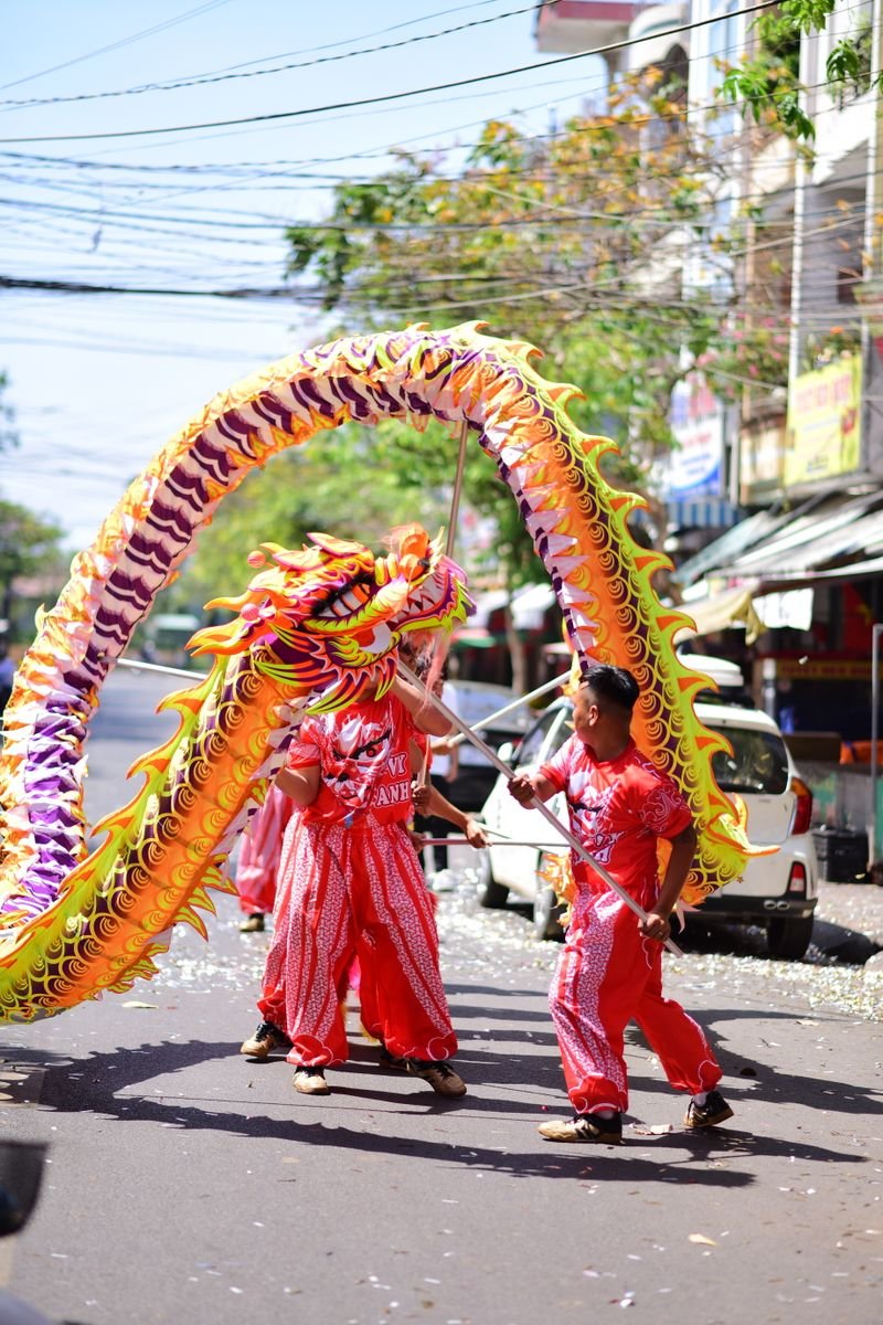 Dragon dance performers in vivid costume at a street festival celebration