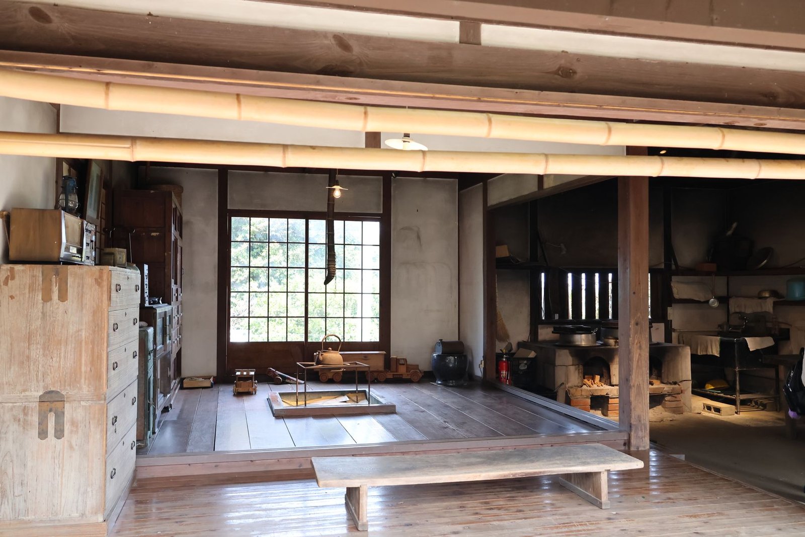 Traditional Japanese hearth with hanging kettle inside a gassho-zukuri farmhouse interior