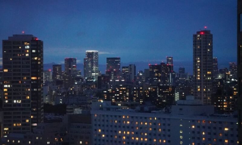 Tokyo skyline at night with illuminated skyscrapers, including the Ikebukuro area
