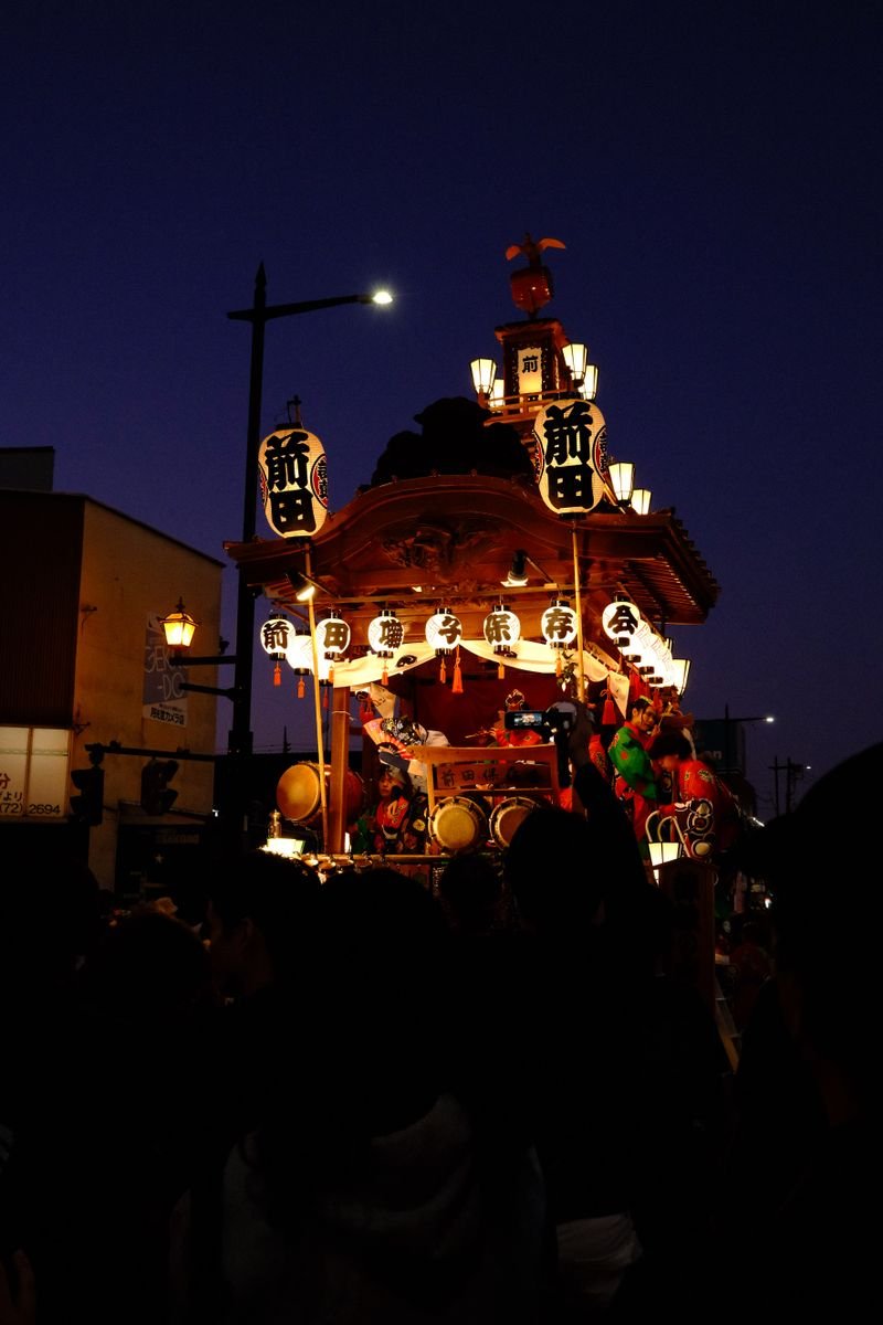 Illuminated Japanese festival float at night