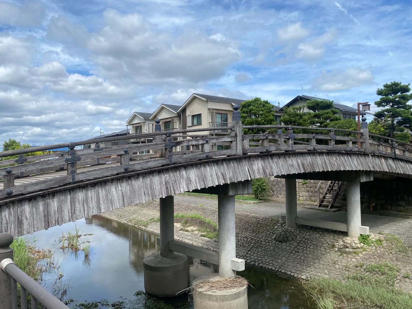 An old stone bridge over a quiet canal in Japan