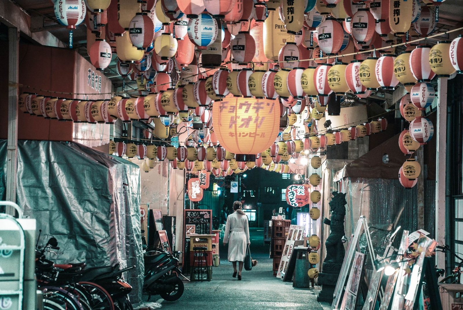 Nighttime festival street scene with glowing lanterns and food stalls