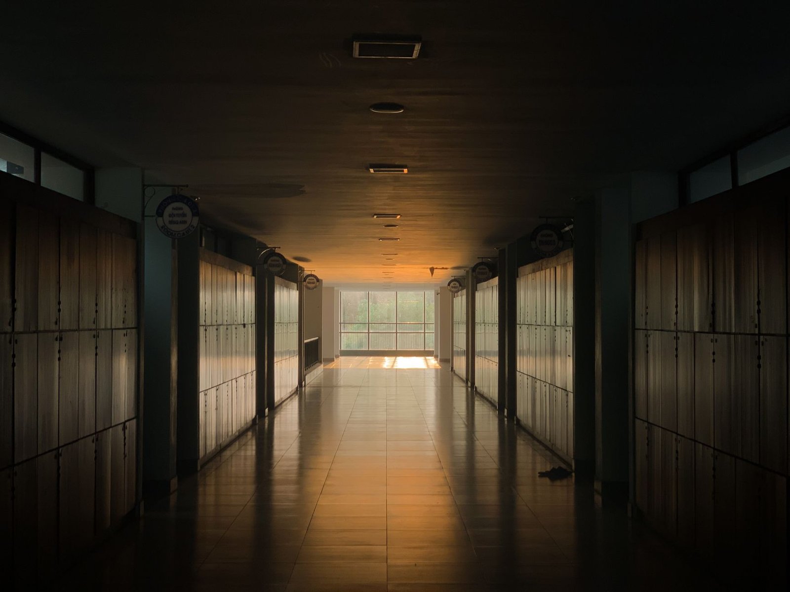 Sunlit empty Japanese-style school corridor with lockers
