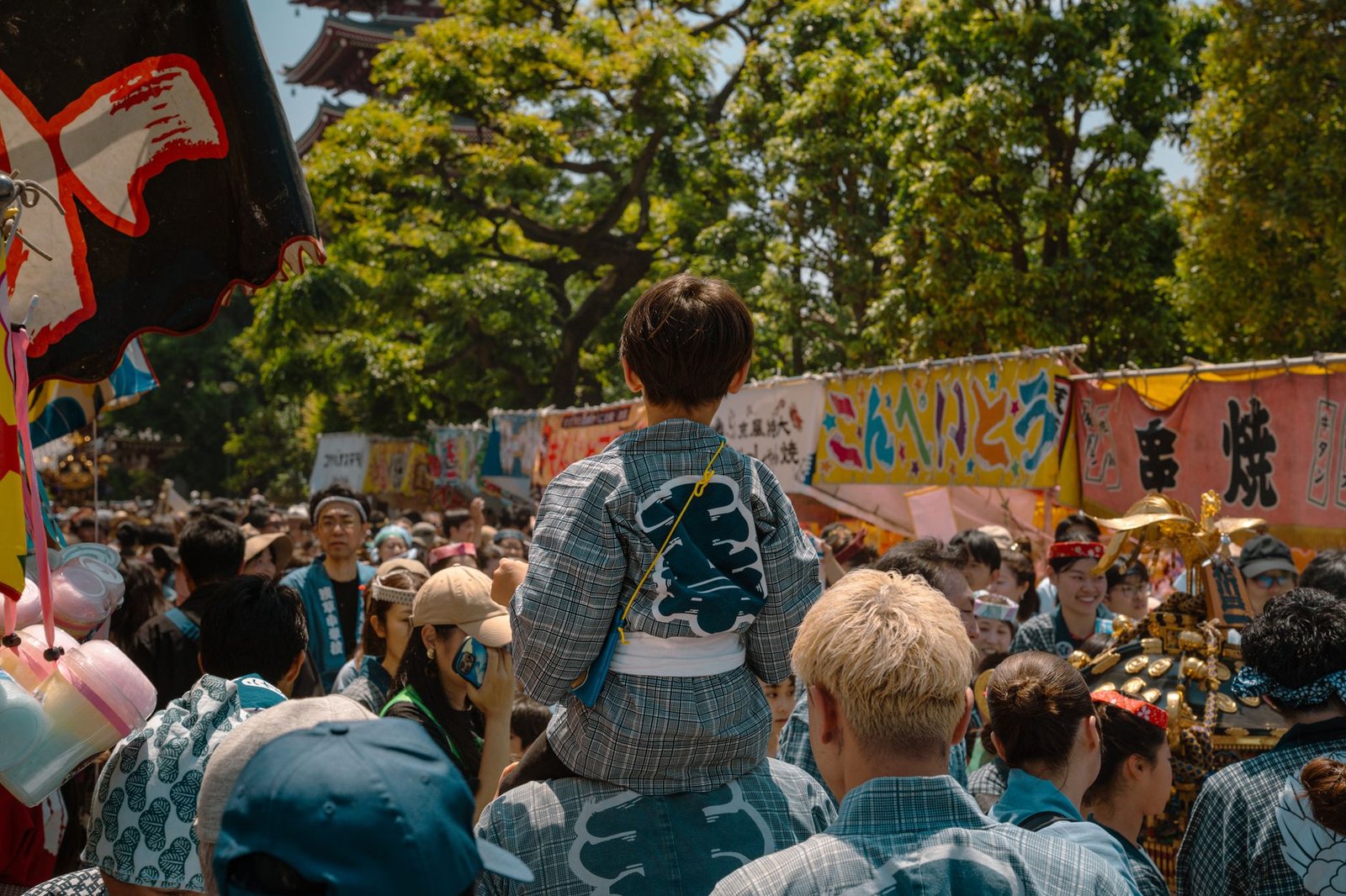 Crowd gathered at a traditional Japanese summer festival with a portable shrine