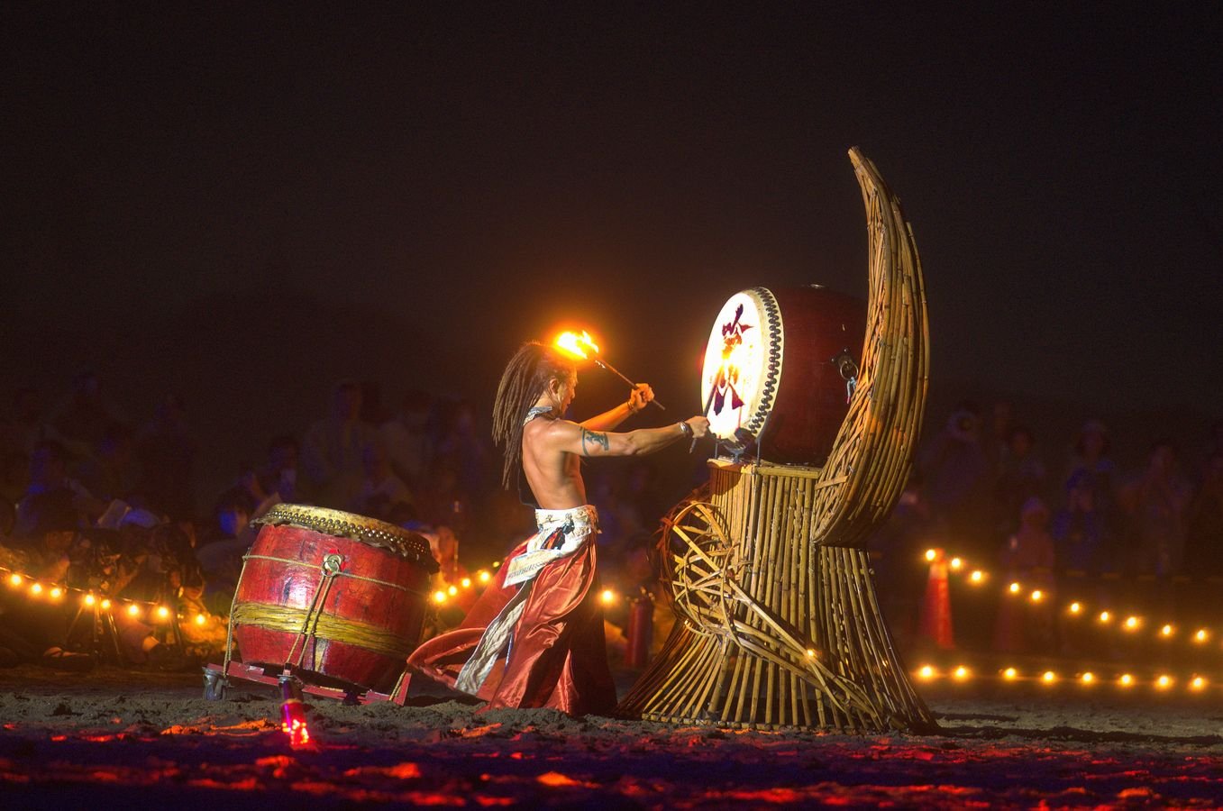 Taiko drummers performing at night during a Japanese festival