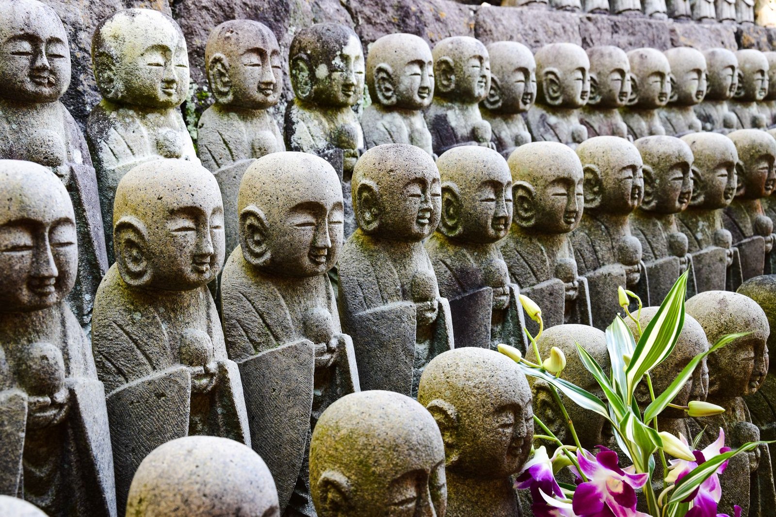 Rows of small stone Jizo statues at a Japanese temple