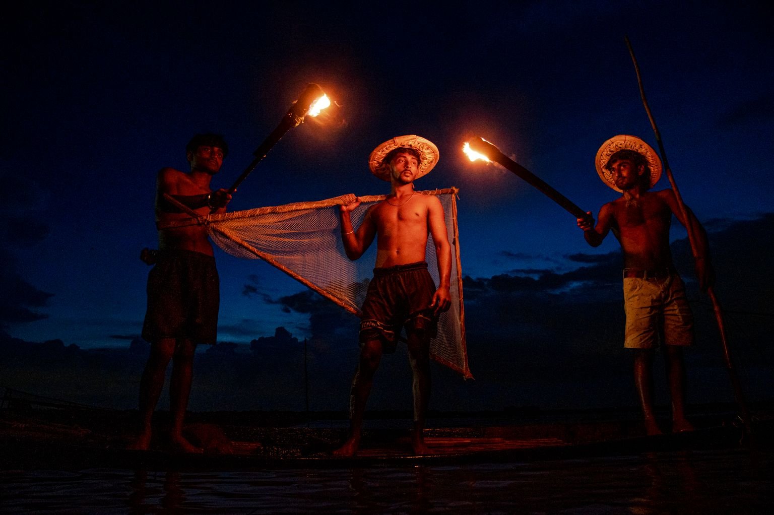 Torches reflecting on dark water at night