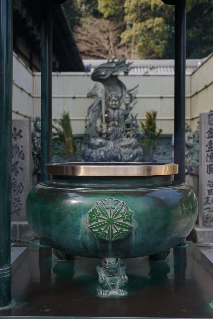Large bronze incense burner at a traditional Japanese Buddhist temple