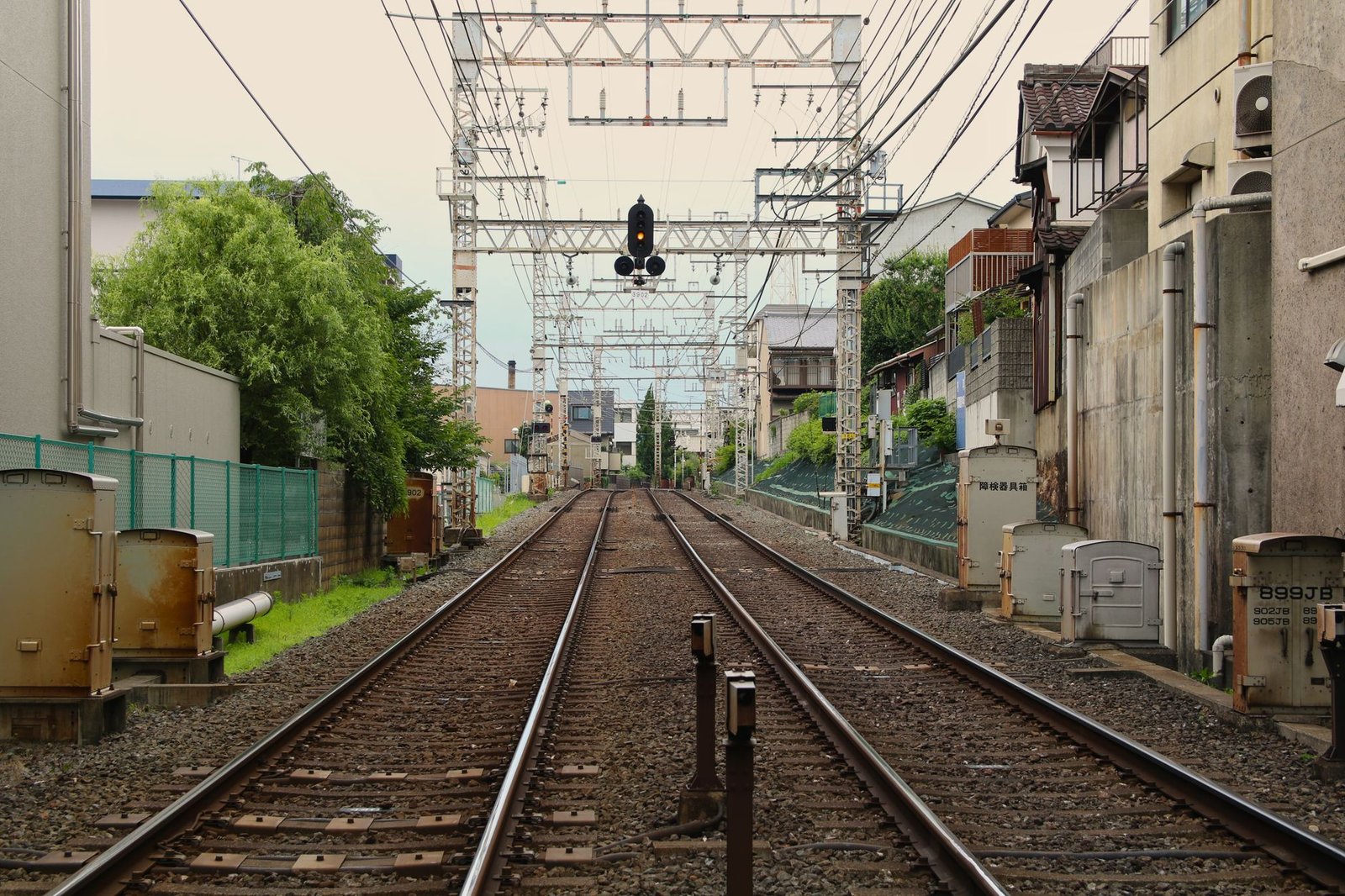 Railway tracks running through a quiet, green corner of Japan