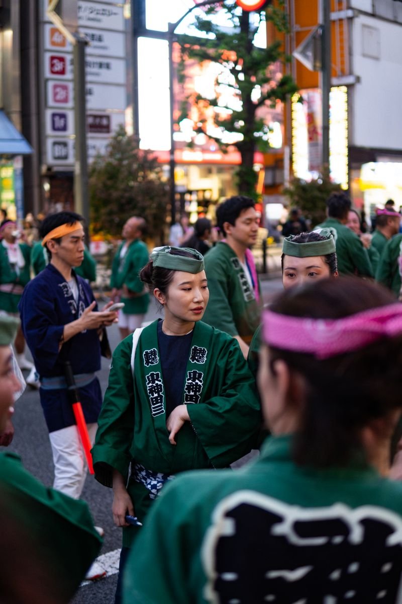 People in traditional Japanese clothing gathered at a lively summer street festival