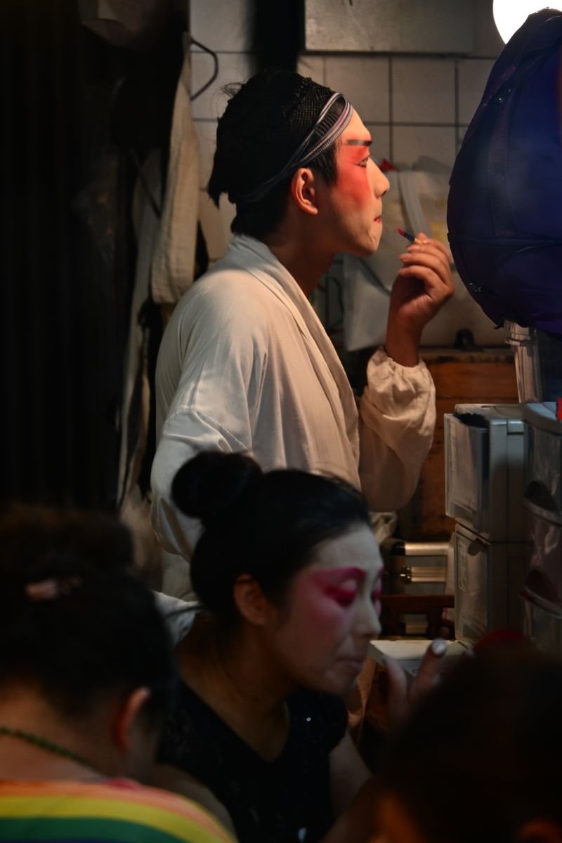 Actor having traditional stage makeup applied backstage
