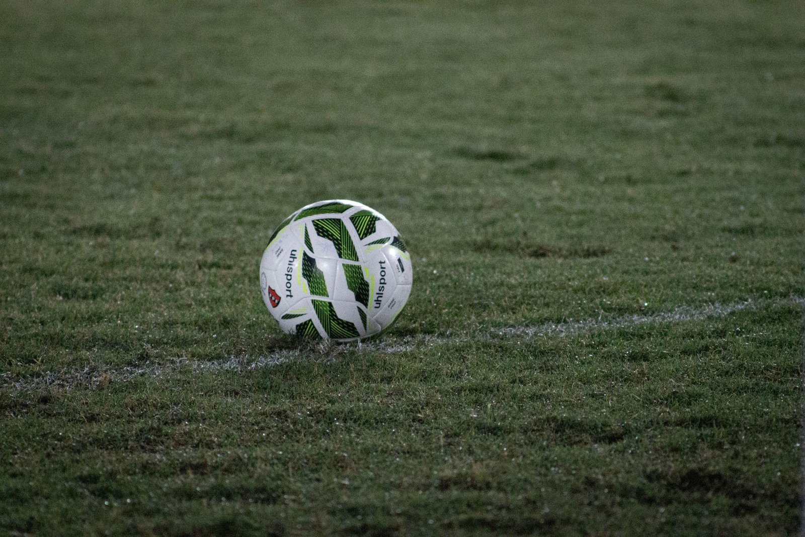 A football resting on a grass field, evoking the ball-game charms now associated with the shrine