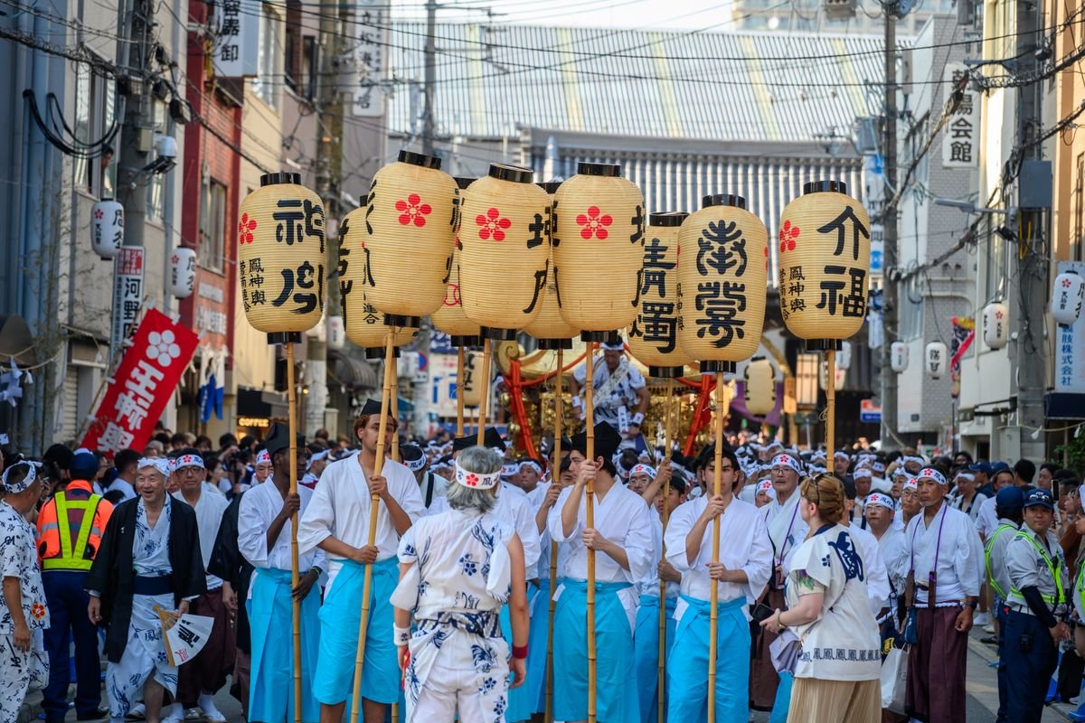 Crowded traditional Japanese street festival with lanterns