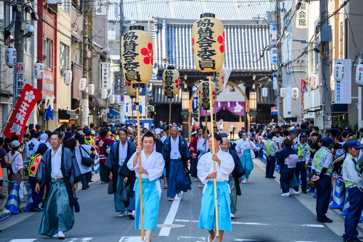 A traditional Japanese festival parade moving through a city street