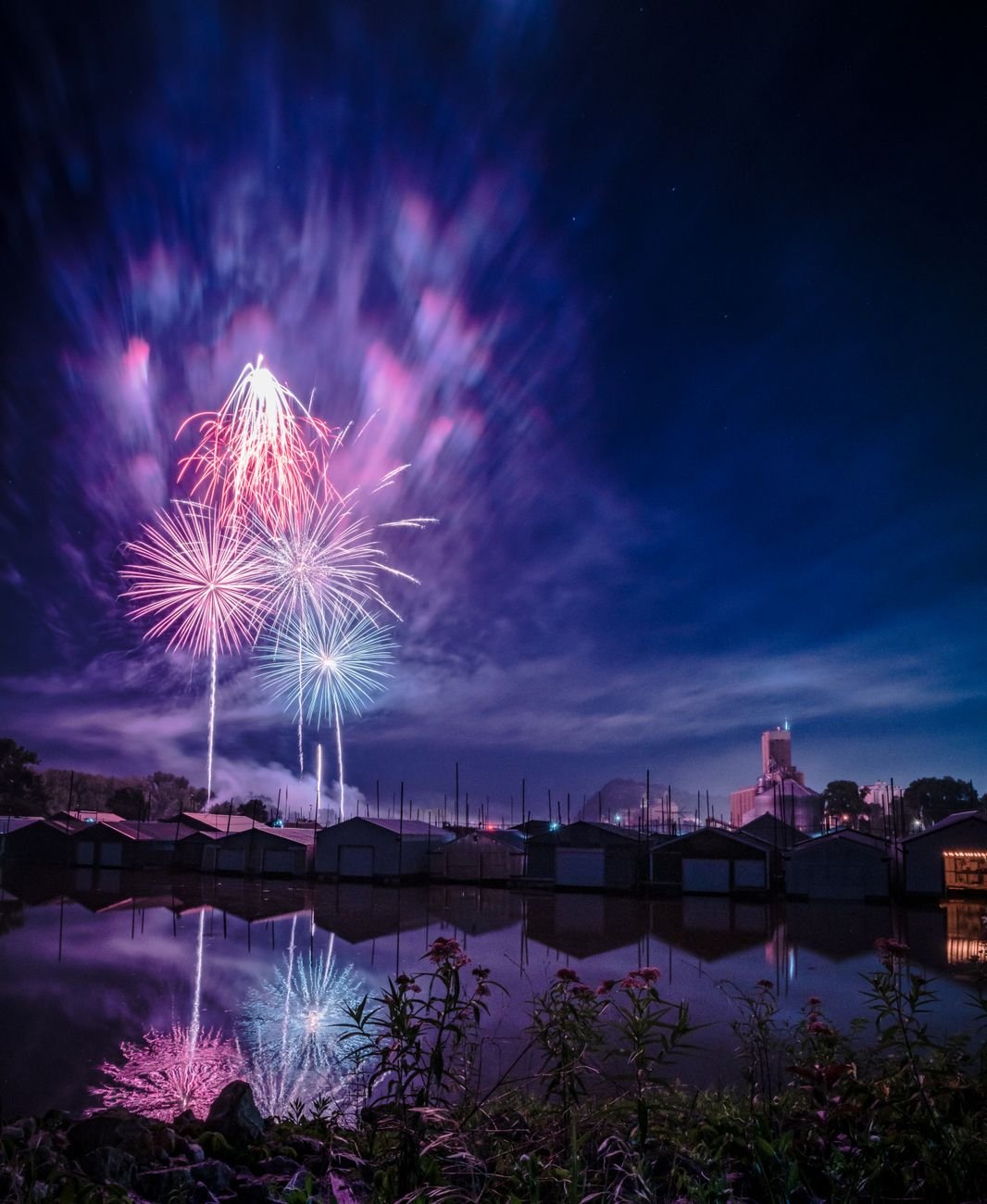 Fireworks reflecting over water at night